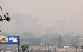 Downtown Minneapolis is barely visible from Ridgway Parkway on Tuesday morning.