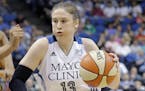 Minnesota Lynx guard Lindsay Whalen (13) drives to the basket against Tulsa Shock forward Plenette Pierson, left, during the first half of a WNBA bask