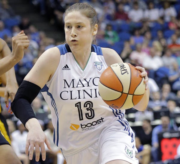 Minnesota Lynx guard Lindsay Whalen (13) drives to the basket against Tulsa Shock forward Plenette Pierson, left, during the first half of a WNBA bask