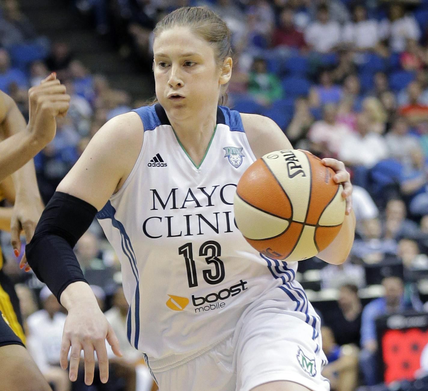 Minnesota Lynx guard Lindsay Whalen (13) drives to the basket against Tulsa Shock forward Plenette Pierson, left, during the first half of a WNBA basketball game in Minneapolis, Friday, June 5, 2015. Whalen had a game-high 26 points as the Lynx won 83-75. (AP Photo/Ann Heisenfelt)