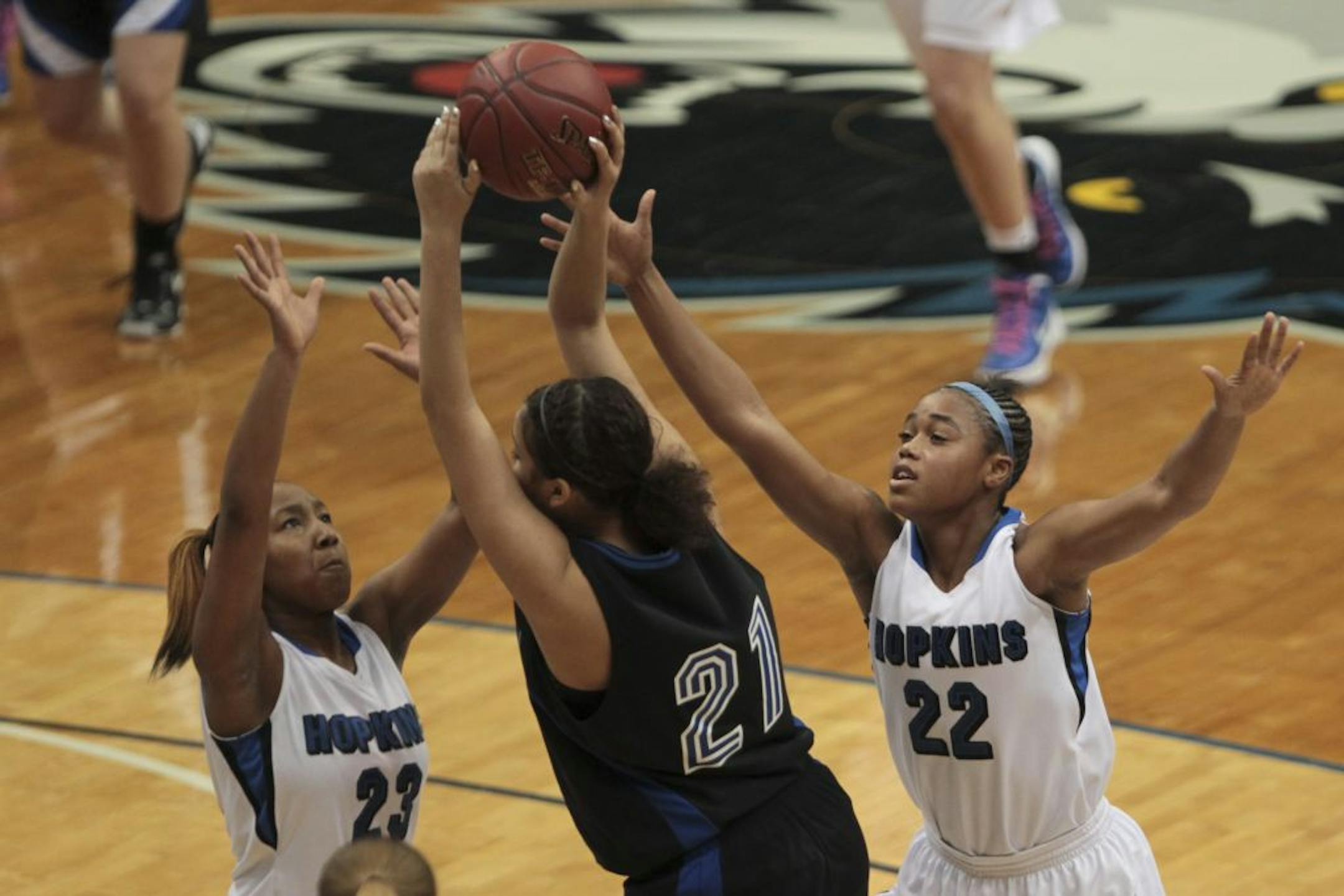 Hopkins' Viria Livingston, left, and TT Starks double-teamed Eastview's Tyra Johnson in the first half. The Royals built a 33-13 halftime lead in rolling to a 55-31 victory.