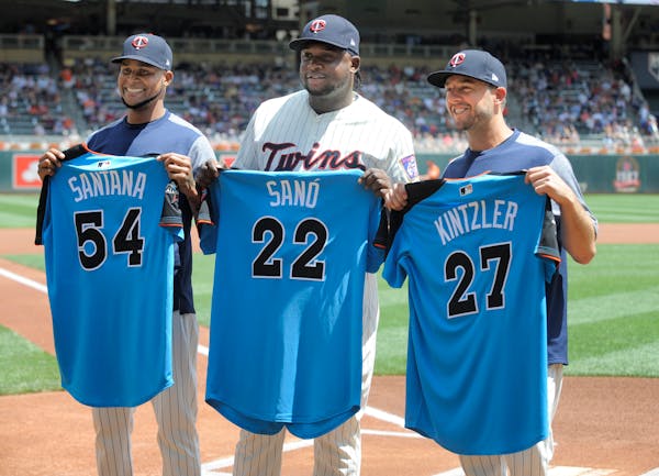 Minnesota Twins' Ervin Santana (54), Miguel Sano (22) and Brandon Kintzler (27) hold their American League All-Star jerseys