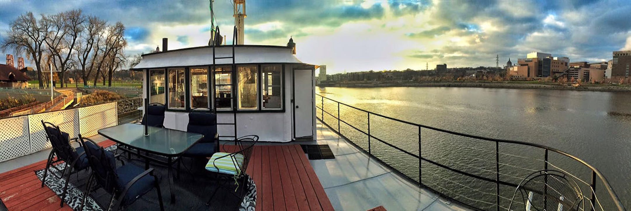 The upper deck of the refurbished towboat offers sunset Mississippi river views.