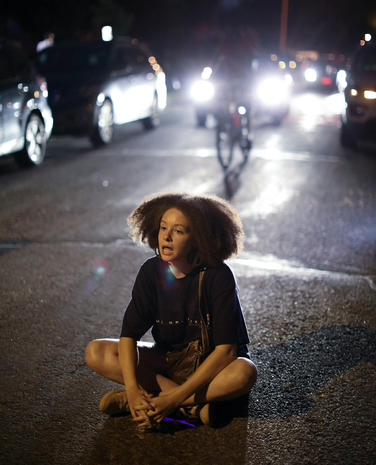 A vigil organizer had everyone remaining as it was winding down speak Thurman Blevins' name. Bella Dawson spoke his name when it was her turn as she sat on the pavement of Camden Ave. N.