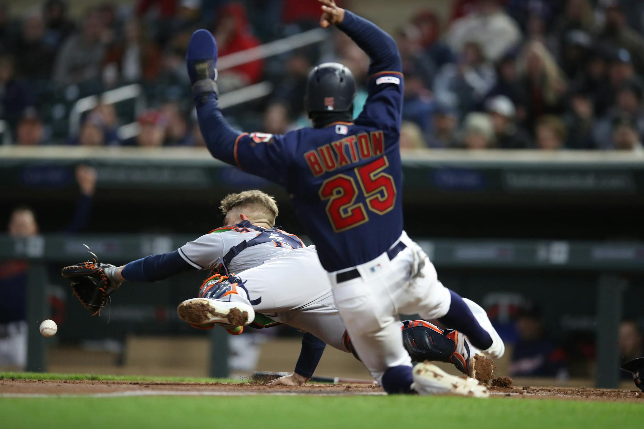 Twins center fielder Byron Buxton scored over Houston catcher Max Stassi in the third inning