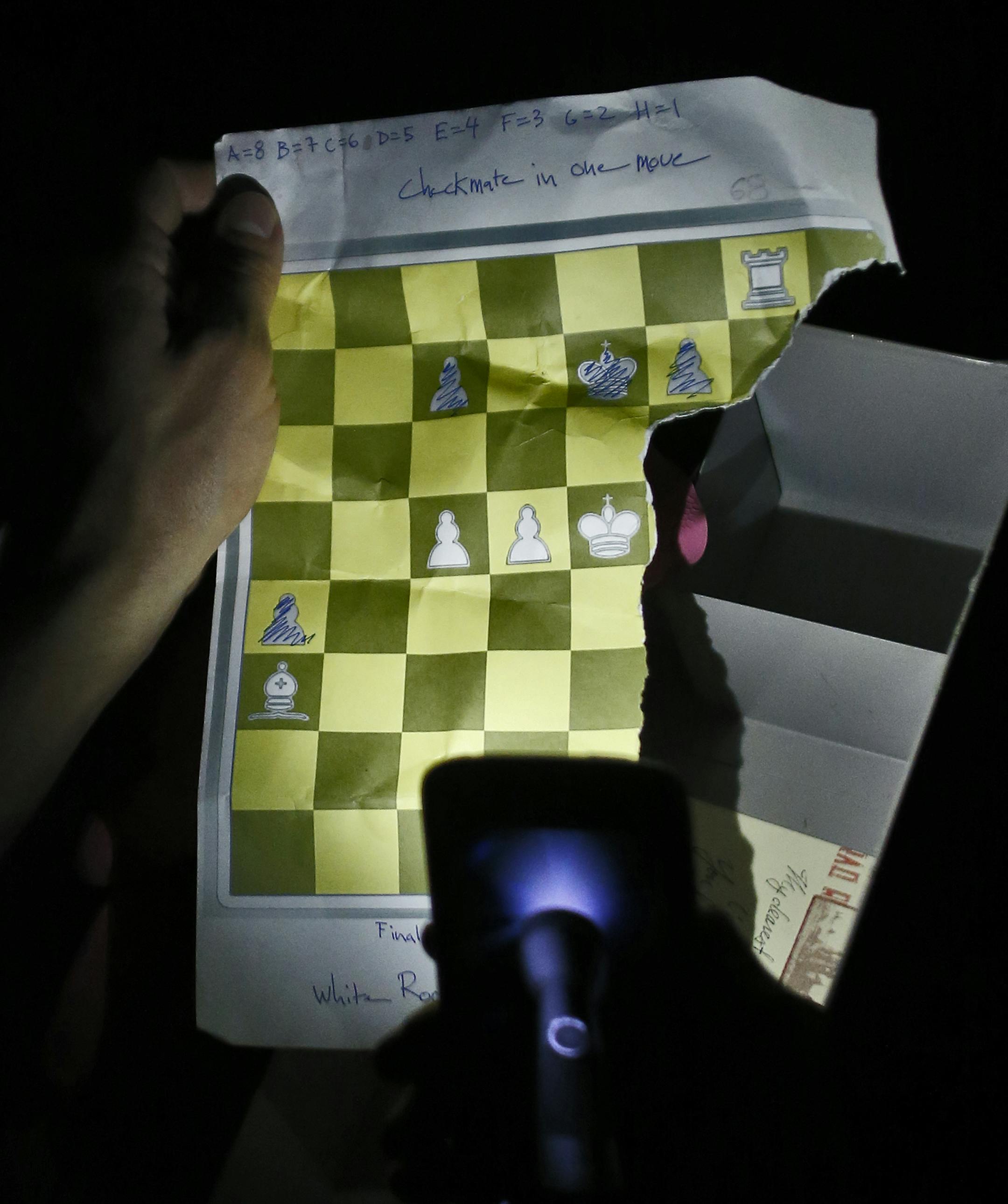 A group works on the various clues presented to them in an effort to find passage out of the riddle room. ] The Riddle Room Bunker in Minneapolis. (MARLIN LEVISON/STARTRIBUNE(mlevison@startribune.com)