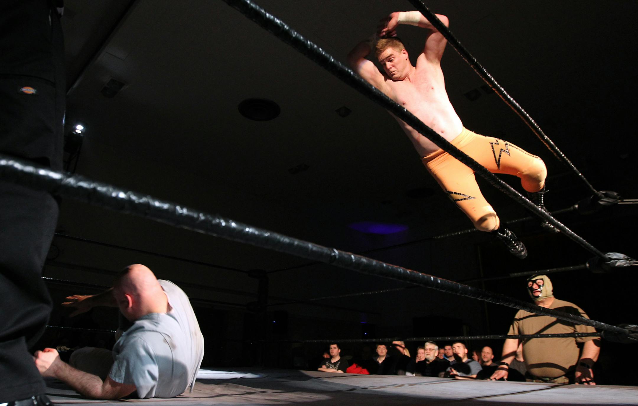 "Shimdog" takes a flying leap at "Horace the Psychopath" during a live pro wrestling show at Elim Lutheran Church in Robbinsdale March 3, 2012. The event was a fundraiser for both Elim and Holy Nativity Lutheran Churches' youth ministries. (Courtney Perry/Special to the Star Tribune)