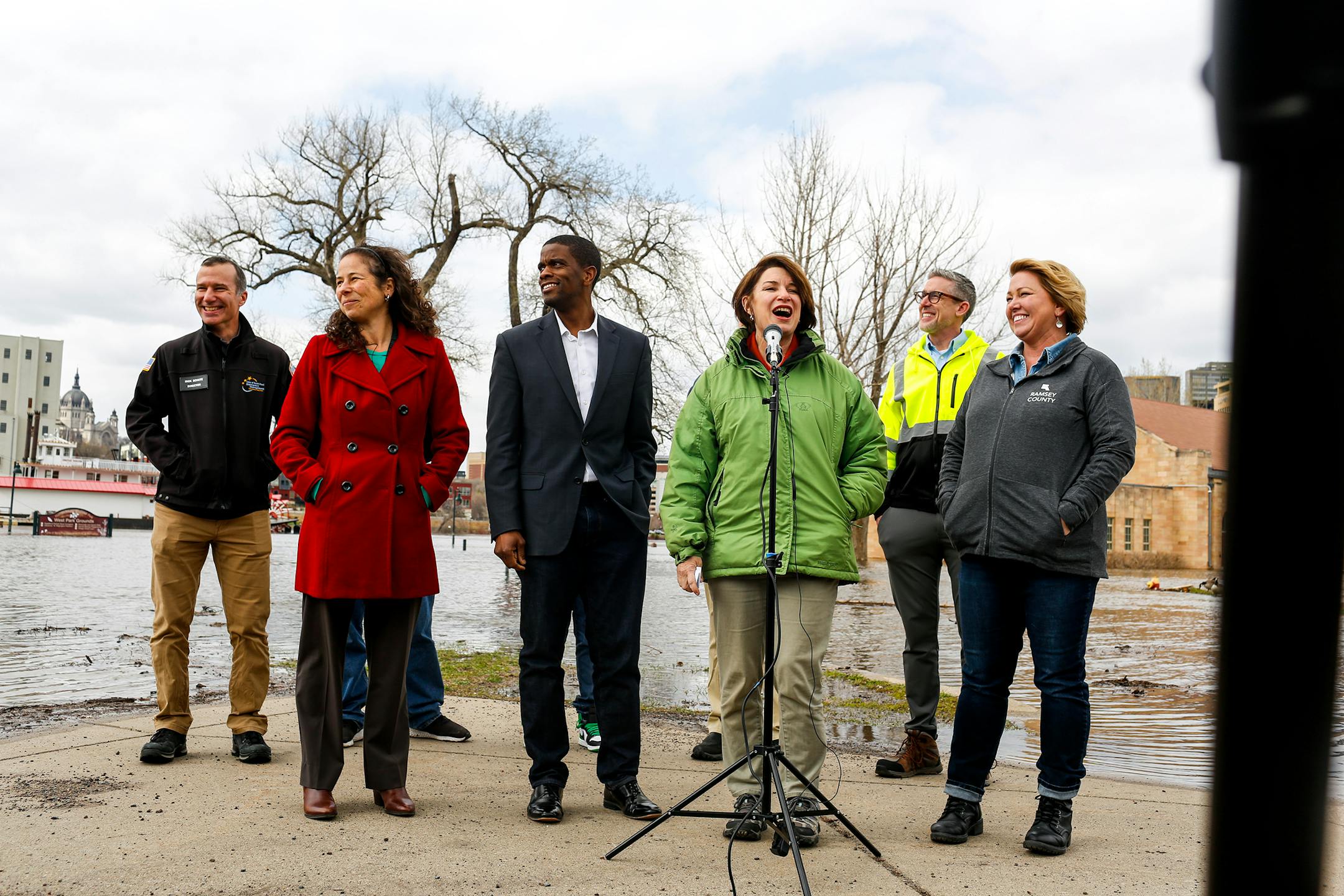 Sen. Amy Klobuchar speaks alongside St. Paul Mayor Melvin Carter during a press conference in front of a flooded Harriet Island Regional Park on Sunday, April 23, 2023.