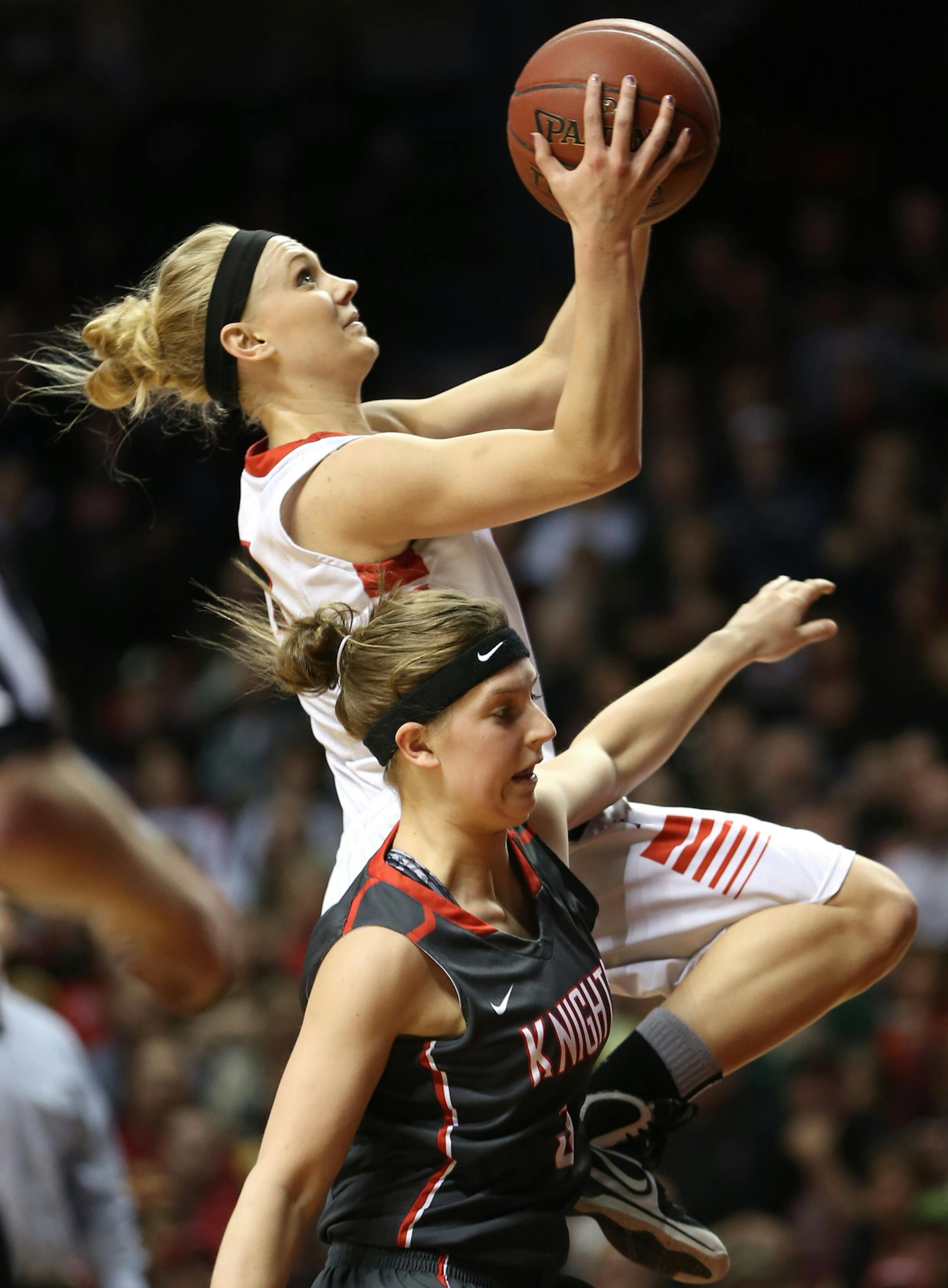 (left to right) NRHEG's Carlie Wagner drove to the basket as she was fouled by Kenyon-Wanamingo's Emily Ashland.] Girls Basketball Tournament, 3/22/14, Willams Arena, Class 2A championship game, Kenyon-Wanamingo vs New Richland-H-E-G. Bruce Bisping/Star Tribune bbisping@startribune.com Carlie Wagner, Emily Ashland/roster.