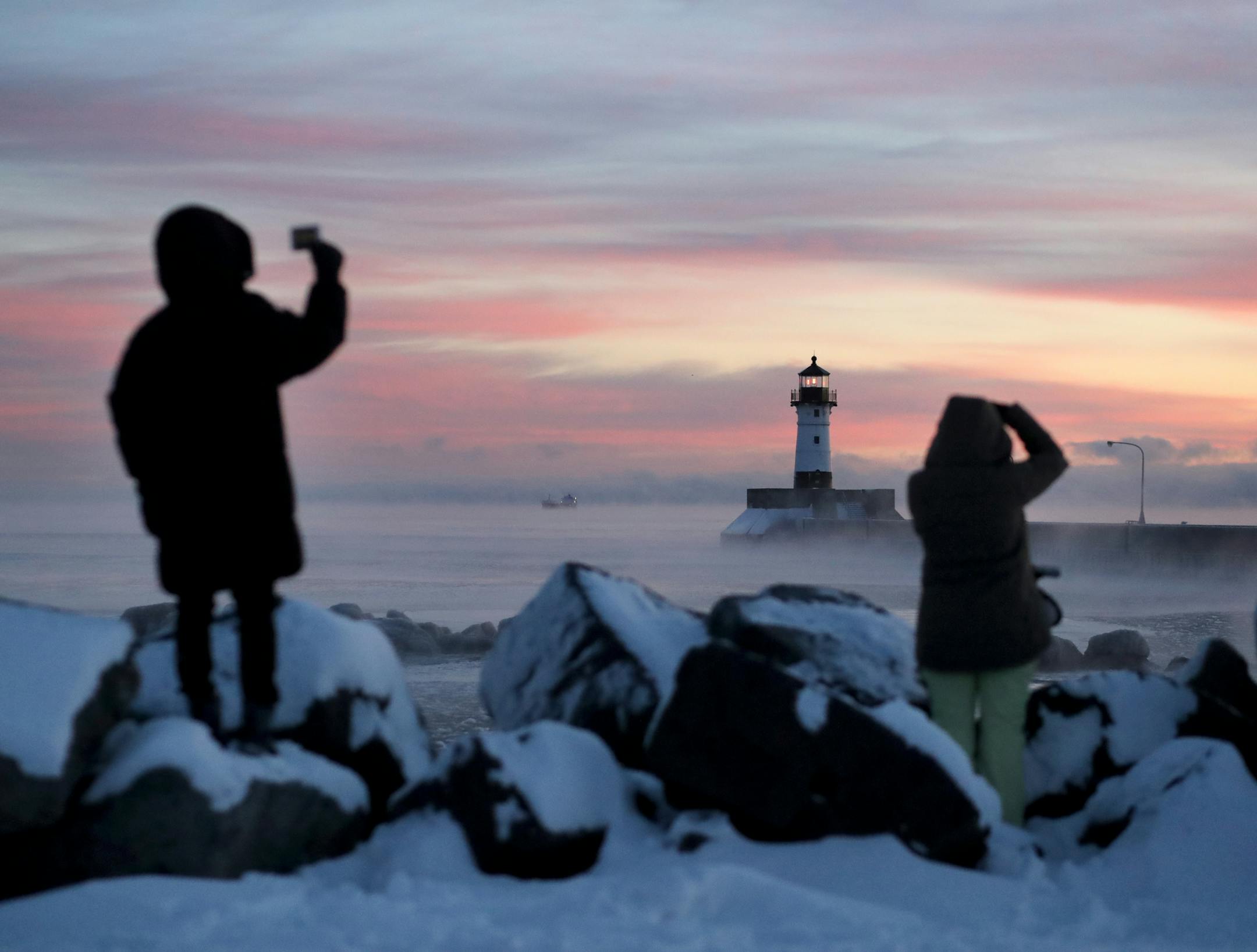 Photographers document the early morning scene as the Tim S. Dool , a 730 foot lake freighter built in 1967, makes its way into Duluth Harbor under the new light of 2019, Tuesday, January 1, 2019 in Duluth, MN.] DAVID JOLES &#x2022; david.joles@startribune.com Sun rise in Duluth Harbor on the first day of the new year.