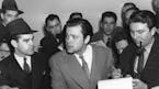 Orson Welles, center, explains to reporters on Oct. 31, 1938 his radio dramatization of H.G. Wells' "War of the Worlds." Meanwhile, Columbia Broadcast