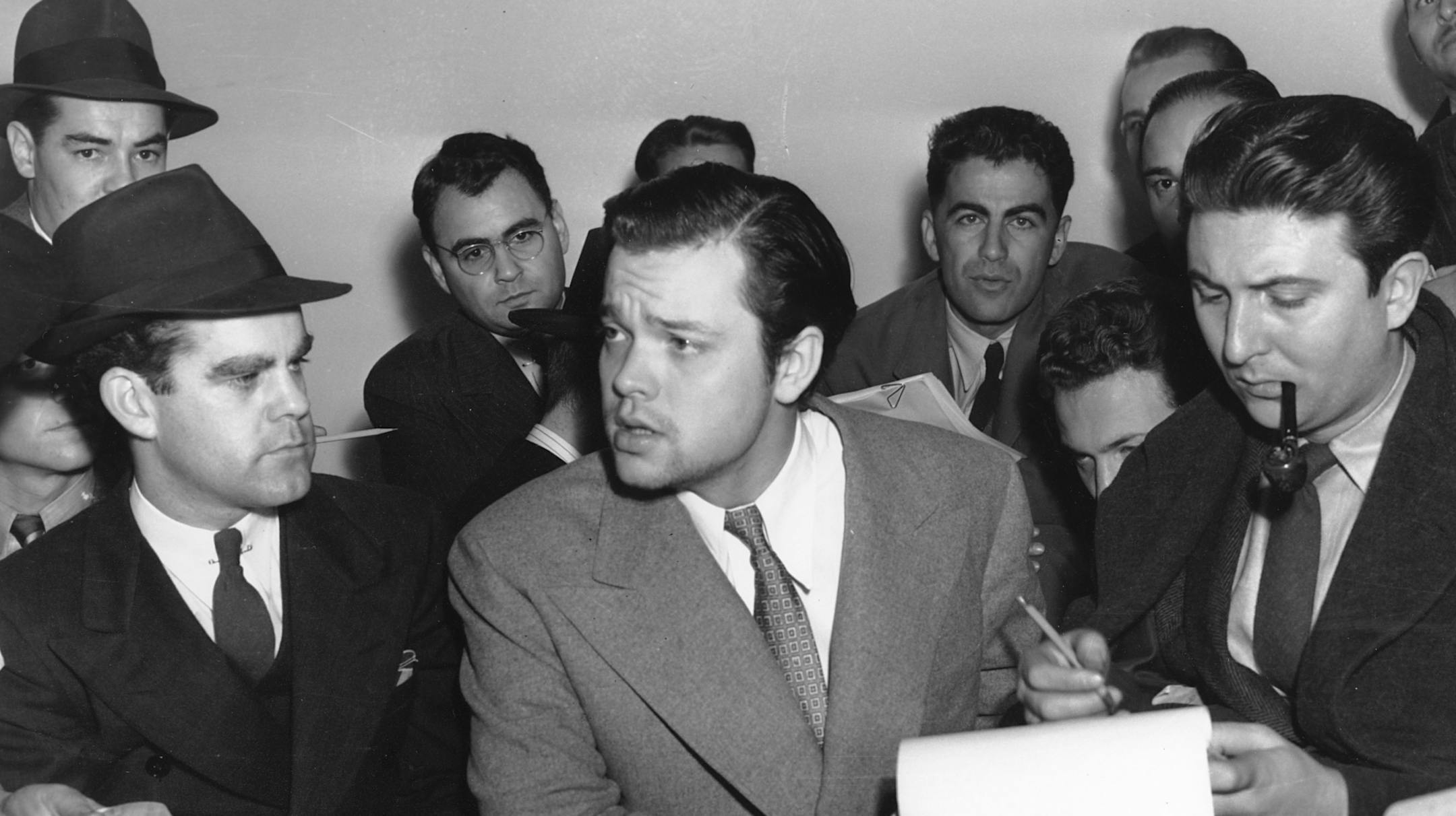 Orson Welles, center, explains to reporters on Oct. 31, 1938 his radio dramatization of H.G. Wells' "War of the Worlds." Meanwhile, Columbia Broadcasting System made public the transcript of the dramatization, which was aired the night of Oct. 30 and caused thousands of listeners to panic because of the realistic broadcast of an imaginative invasion of men and machines from Mars. (AP Photo) ORG XMIT: APHS104