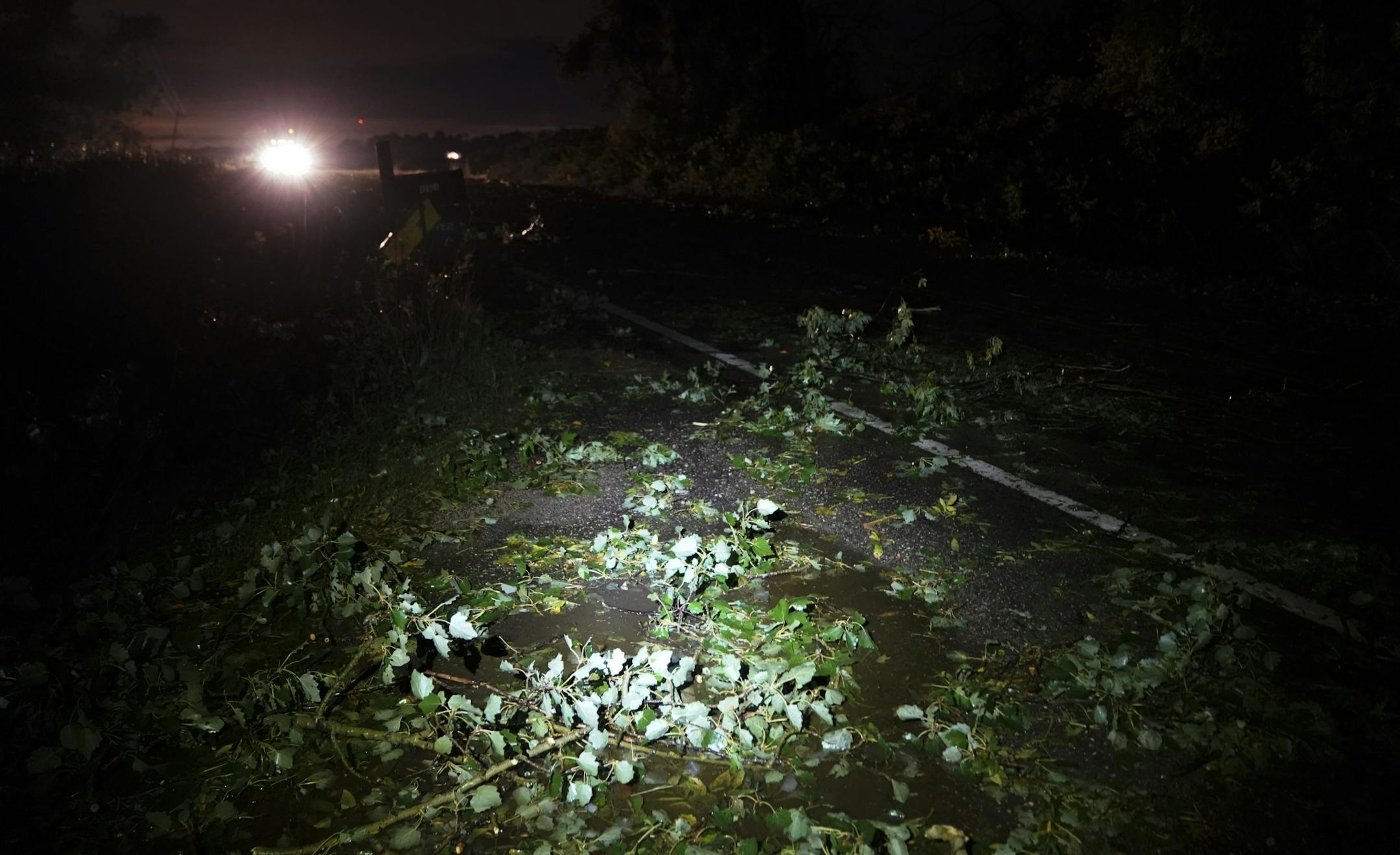 A path of debris cut across a highway near the site of a reported tornado which tore through the area earlier Thursday night near Dundas in Northfield.