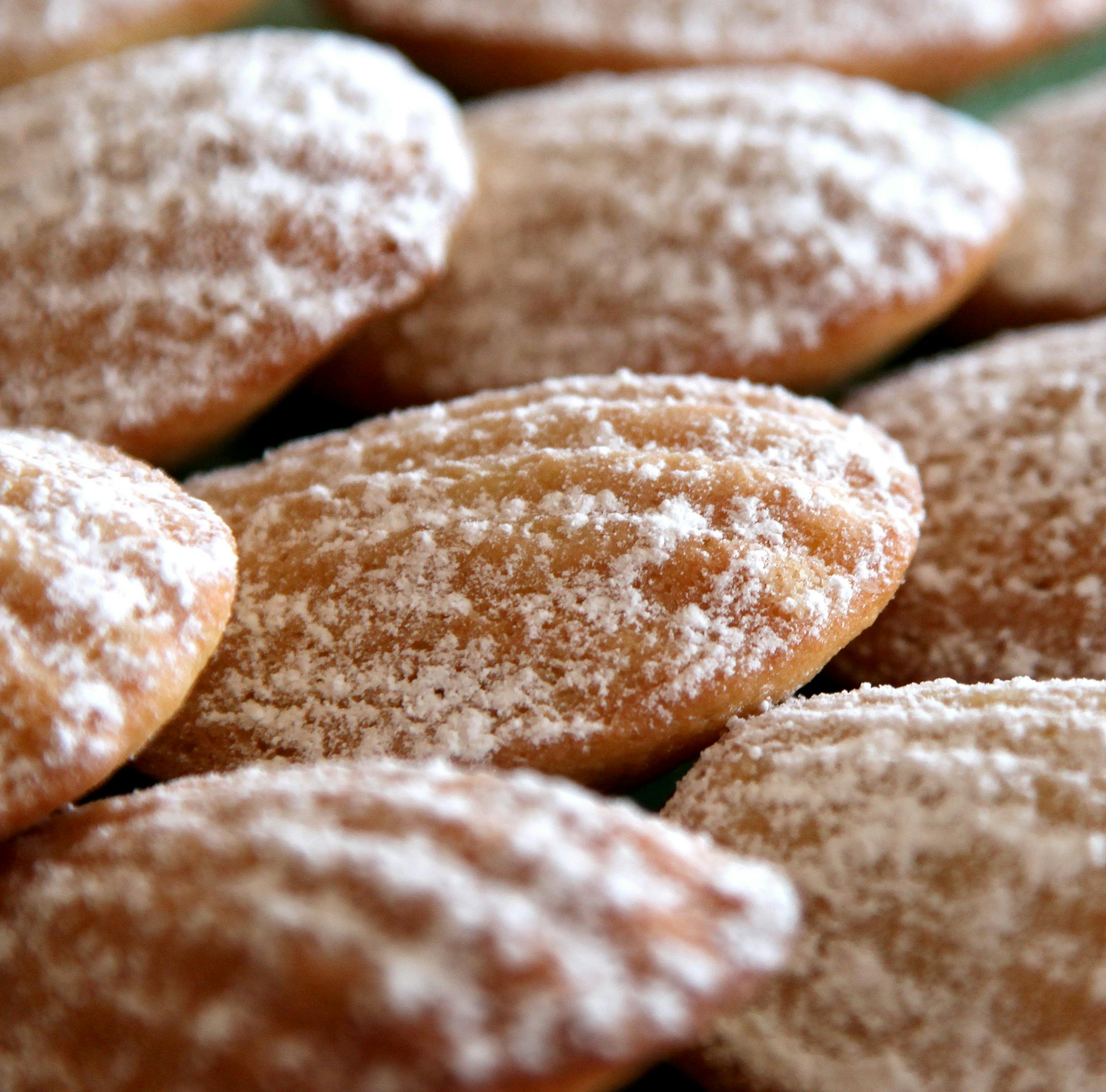 Lemon madeleines dusted with powdered sugar.