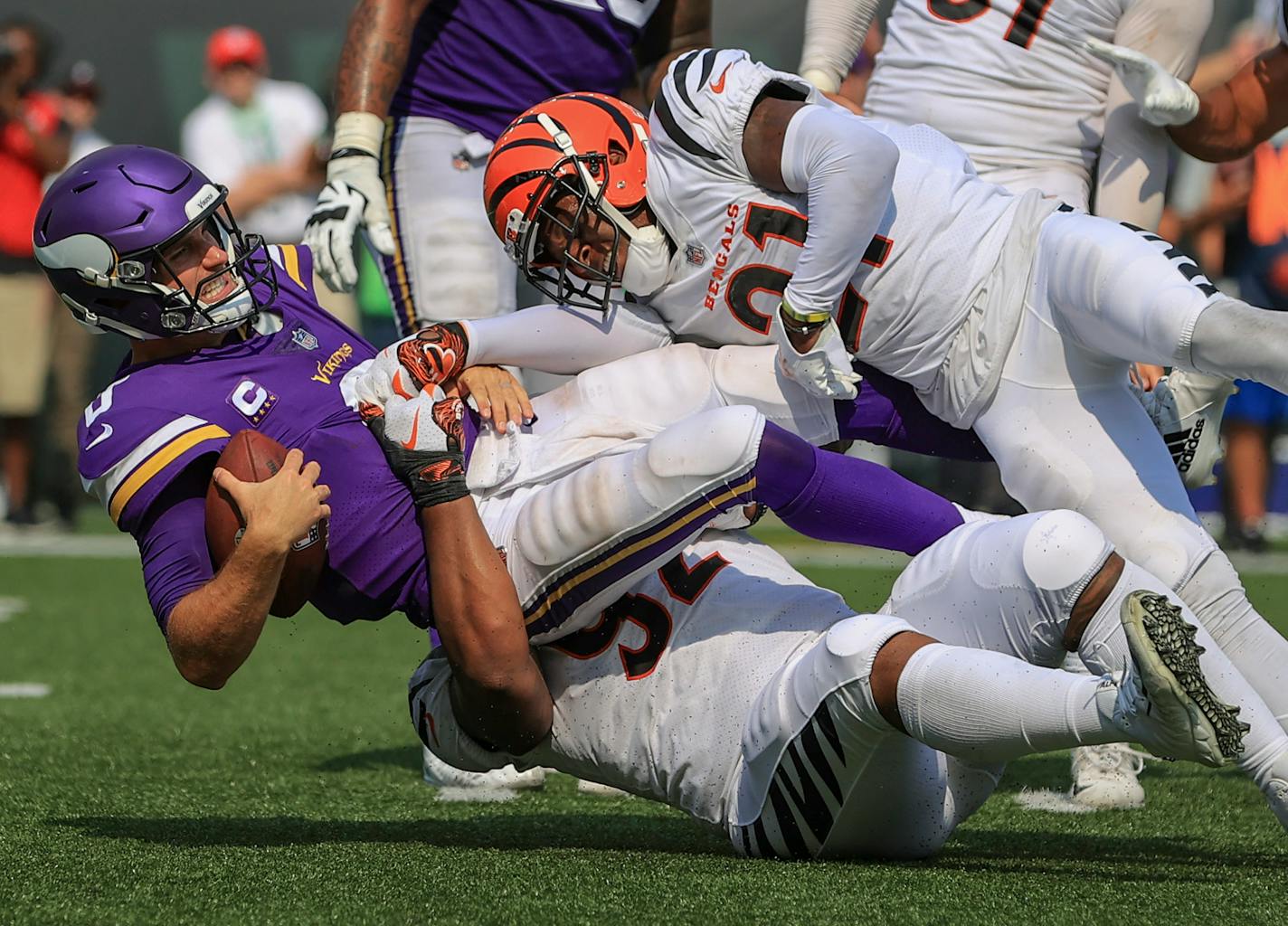 Cincinnati Bengals defensive end Noah Spence (52) and cornerback Mike Hilton (21) sack Minnesota Vikings quarterback Kirk Cousins (8) on Sunday.