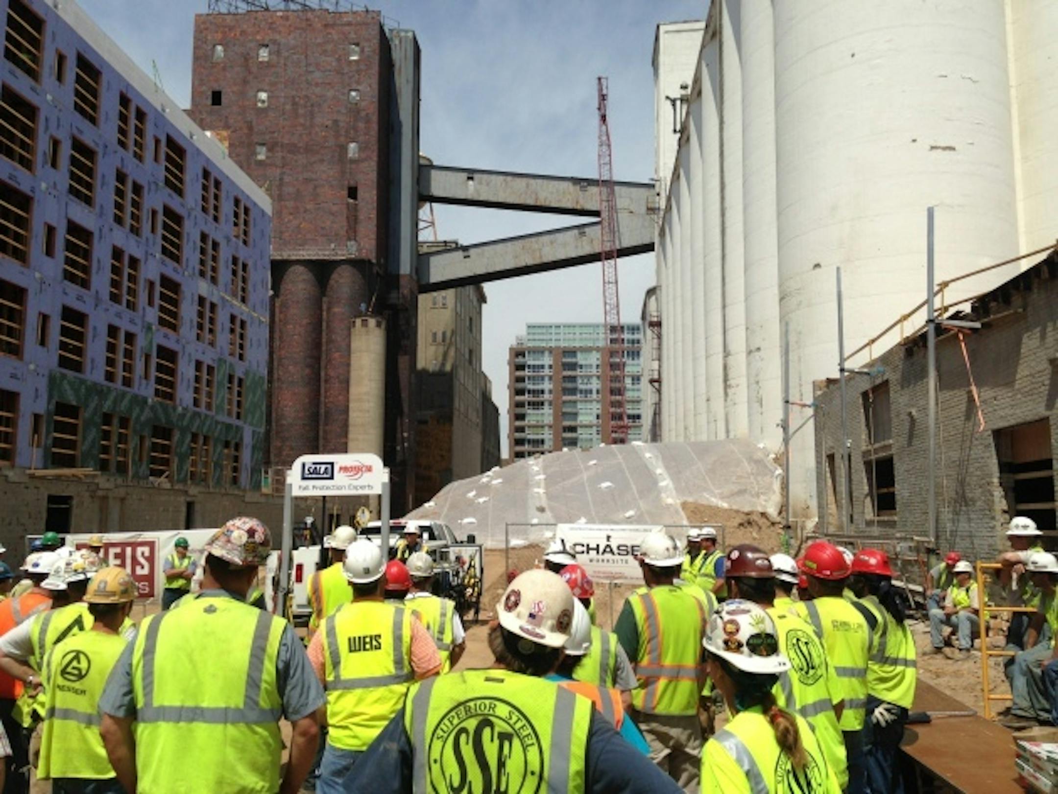 Workers at the A Mill Artists Lofts site in Minneapols gather for demonstration on fall safety.