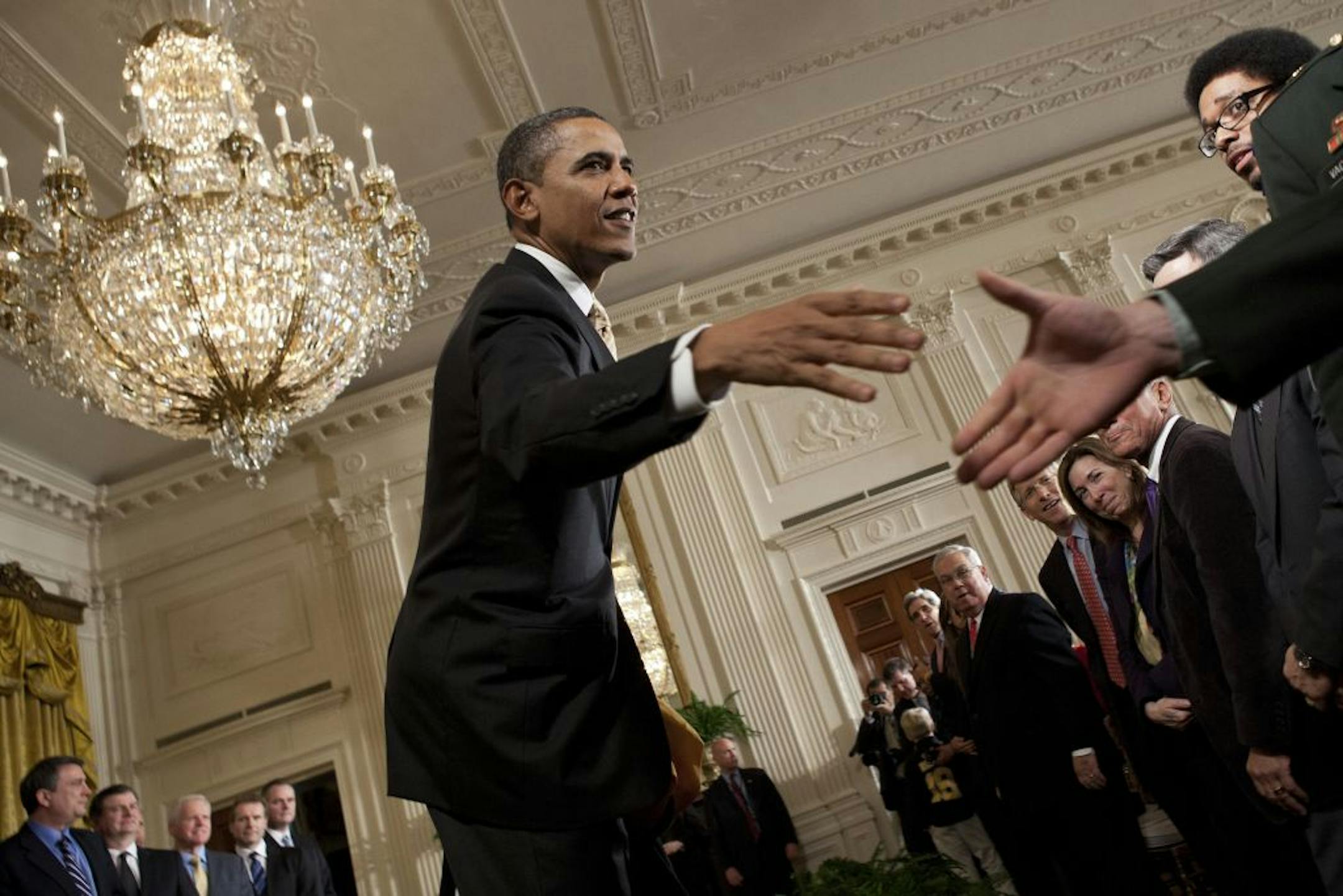 On the eve of his State of the Union address, President Obama greeted visitors Monday at the White House after honoring the Stanley Cup champion Boston Bruins hockey team in the East Room.