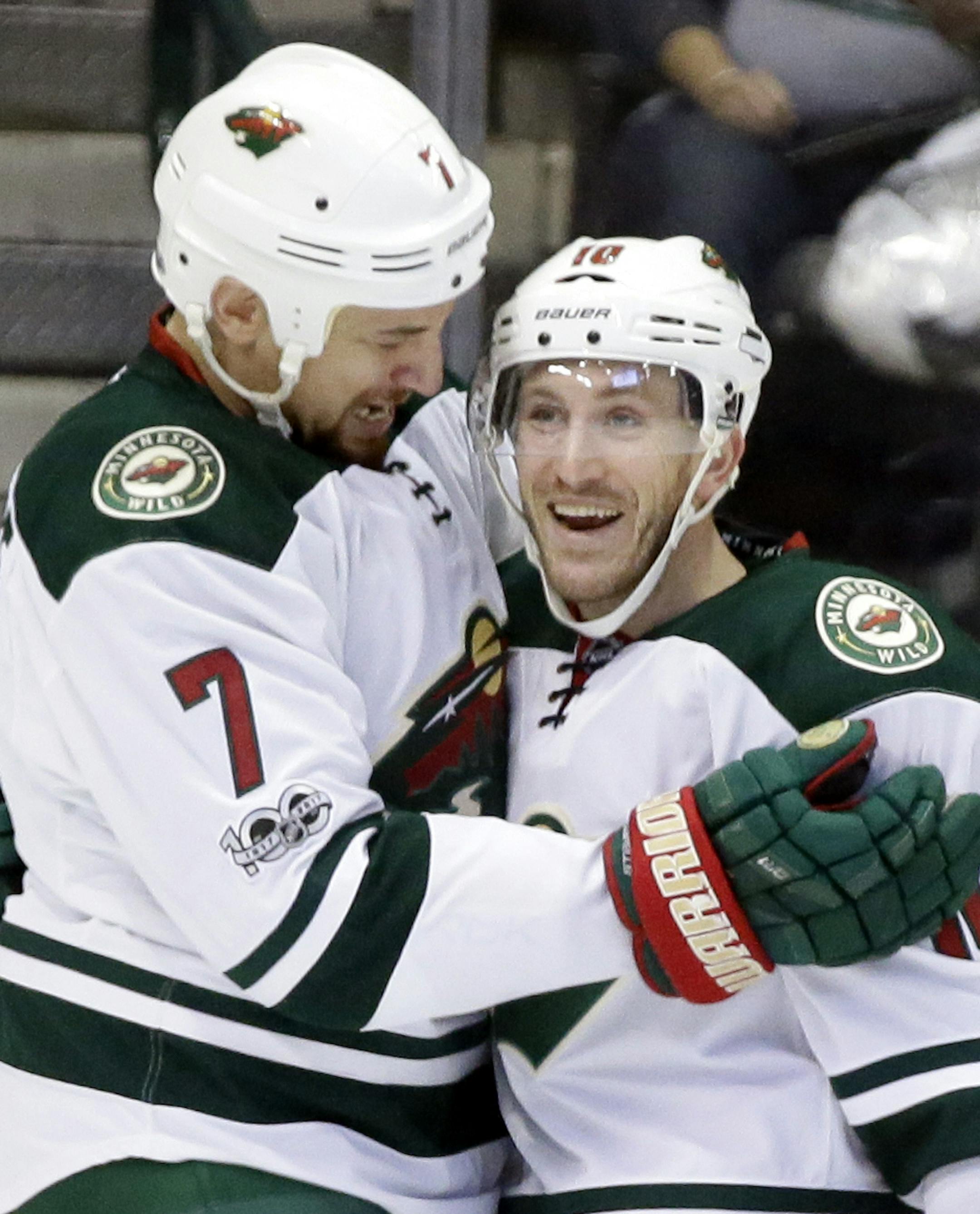 Minnesota Wild right wing Chris Stewart (7) and center Jordan Schroeder (10) celebrate a goal by Stewart in the first period of an NHL hockey game against the Dallas Stars in Dallas, Saturday Jan. 14, 2017. Schroeder had an assist on the score. (AP Photo/LM Otero)