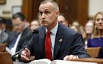 Corey Lewandowski, former campaign manager for President Donald Trump, references a copy of the Mueller Report that he requested, as he testifies to t