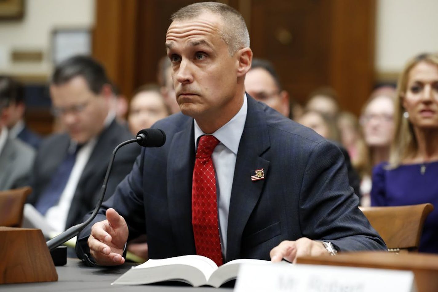 Corey Lewandowski, former campaign manager for President Donald Trump, references a copy of the Mueller Report that he requested, as he testifies to the House Judiciary Committee Tuesday, Sept. 17, 2019, in Washington.