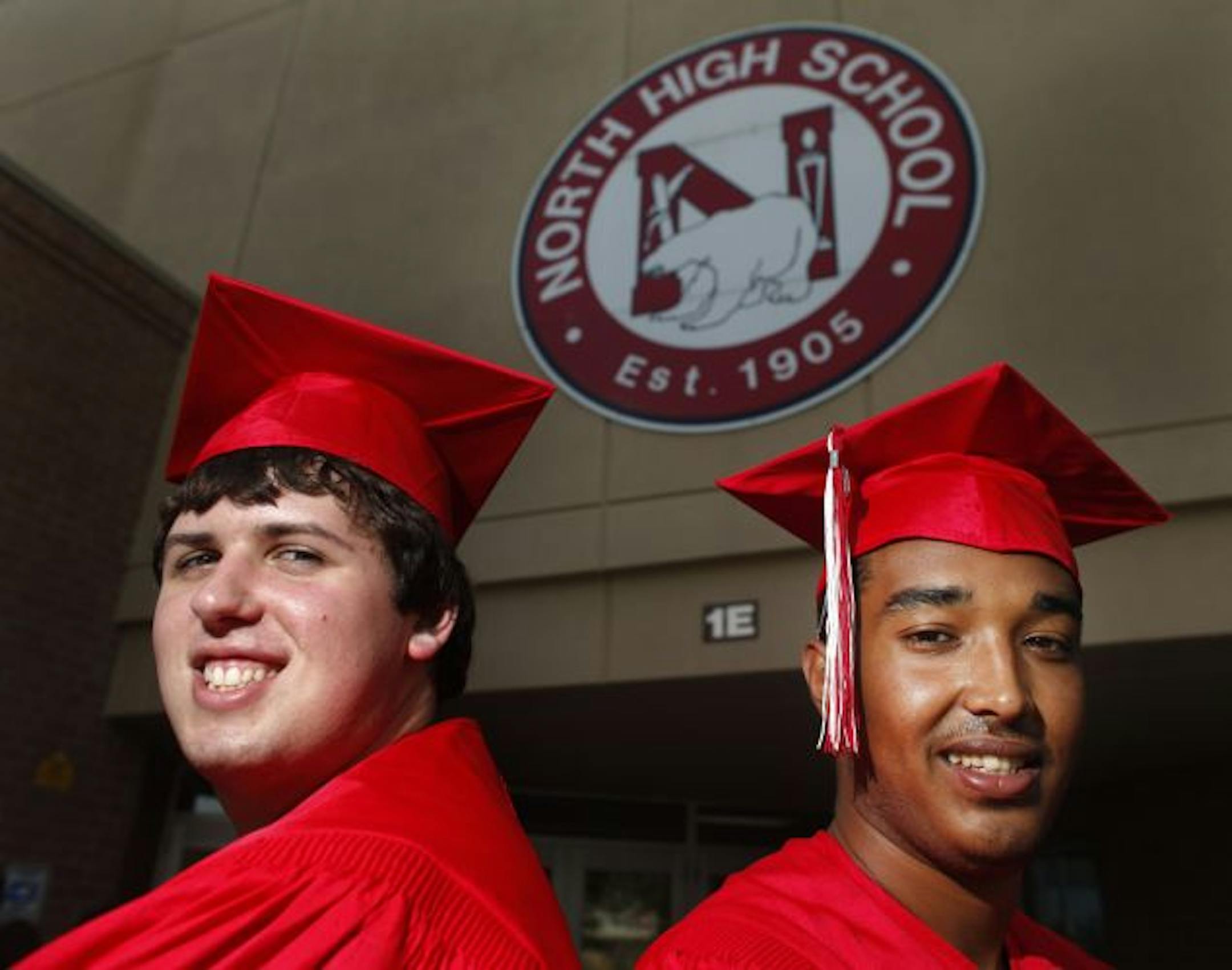 Host brother James Van Zandt, left, and Abdullah Al-Azmi showed off their graduation robes. Al-Azmi was almost sent home last week, but his host family fought to let him stay and graduate.