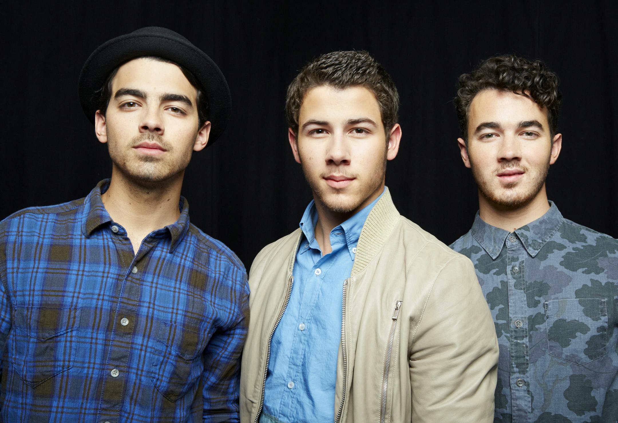 FILE - This April 9, 2013 file photo shows, from left, Joe Jonas, Nick Jonas and Kevin Jonas, of American pop rock band The Jonas Brothers in New York. The band announced Tuesday, Oct. 19, 2013, they're ending their highly successful run. The news comes after the brothers abruptly canceled their tour over creative differences earlier this month. (Photo by Dan Hallman/Invision/AP, File)