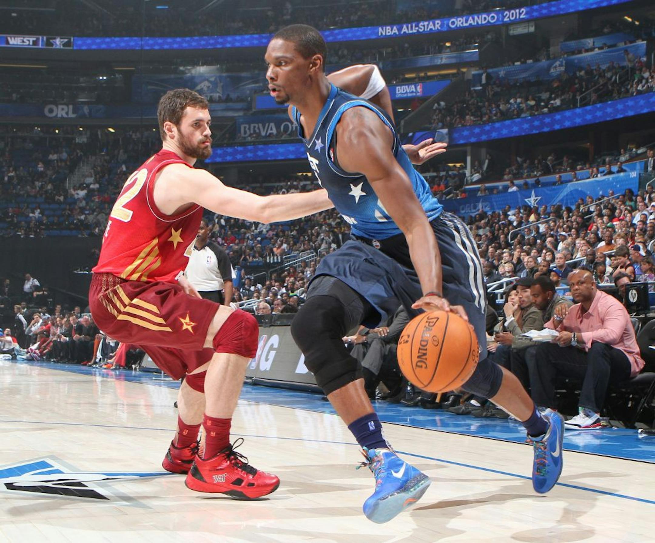 The East's Chris Bosh drove past the Timberwolves' Kevin Love, who finished with 17 points and seven rebounds.