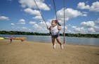 Mia Gonzalez, 2, enjoyed the swings on the beach with her family from Texas, including her aunt Alya Gonzalez as they stayed clear of the water in Lak