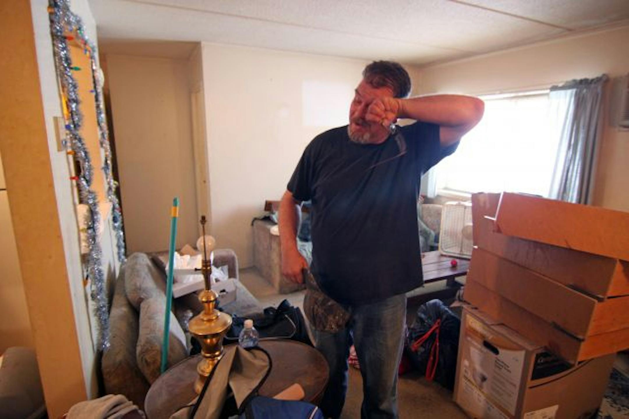 Basement level apartment resident Kyle Dietz is surrounded by his belongings.