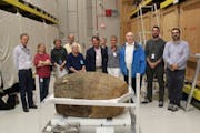 In September, researchers and visitors to the Smithsonian Institution warehouse in Suitland, Md., posed with the ancient sandstone jar given as a gift