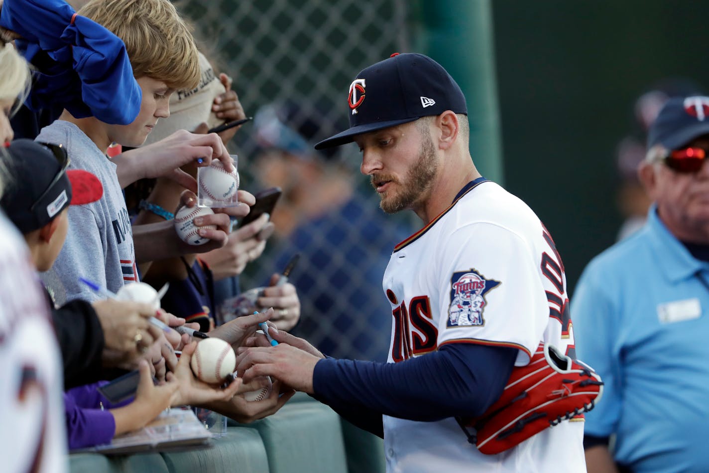 Minnesota Twins third baseman Josh Donaldson signs autographs before a spring training baseball game against the Pittsburgh Pirates Saturday, Feb. 29, 2020, in Fort Myers, Fla. (AP Photo/John Bazemore)