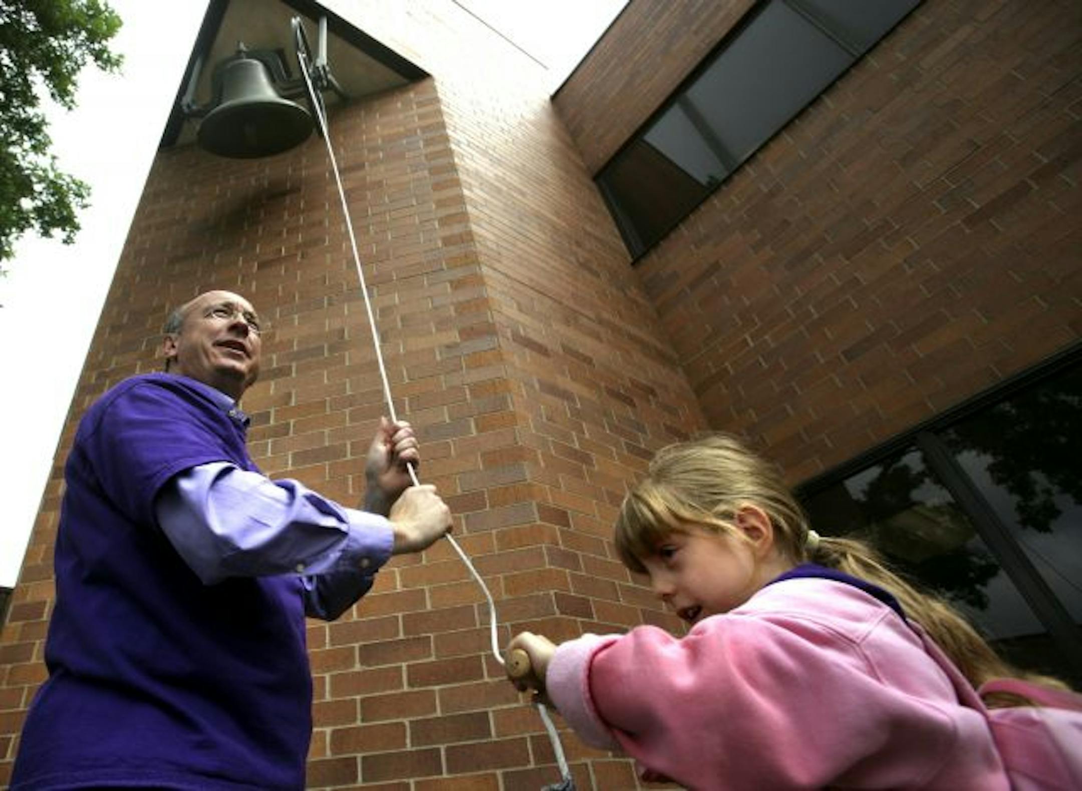 Kindergarten student Hailey Farley, with the help of principal Mark Vandersteen, to ring the bell at�Longfellow Humanities Magnet school which is one of eight in St. Paul set to close on Friday. The school will mark this occaision by allowing each of its 203 students to tug the bell cable, ringing the school bell for the final time. While the school was rebuilt in the 1970s, it kept the bell that was built into the original school some 100 years ago.