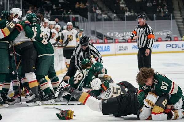 Minnesota Wild left wing Kirill Kaprizov (97) and Vegas Golden Knights defenseman Zach Whitecloud (2) fought on the ice as a big fight broke out when 