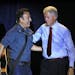 Former President Bill Clinton greets singer/songwriter Bruce Springsteen at a campaign event for President Barack Obama, Thursday, Oct. 18, 2012, in P