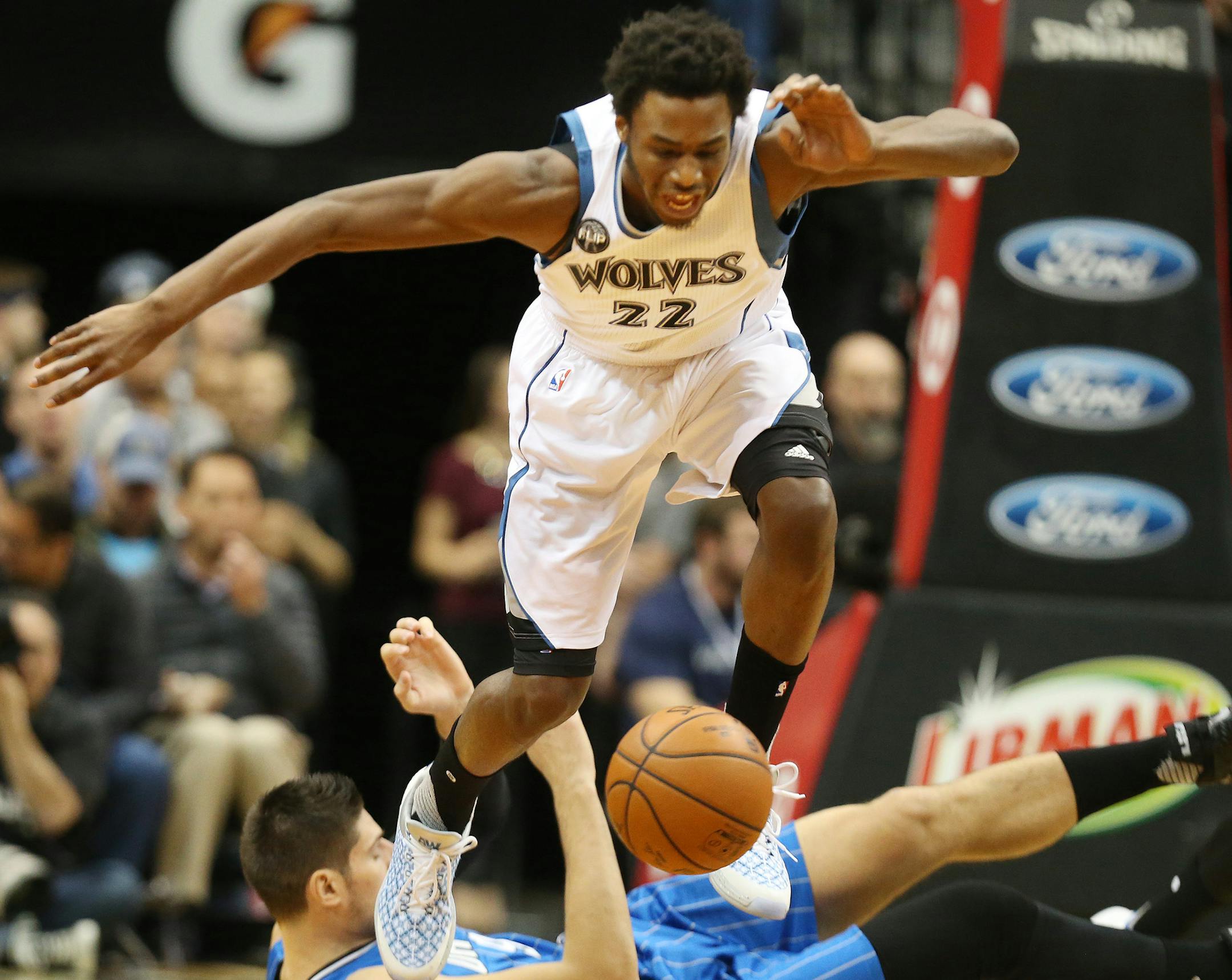 Timberwolves guard/forward Andrew Wiggins chased a loose ball down as the Magic's Nikola Vucevic fell to the floor at Target Center on Monday night.