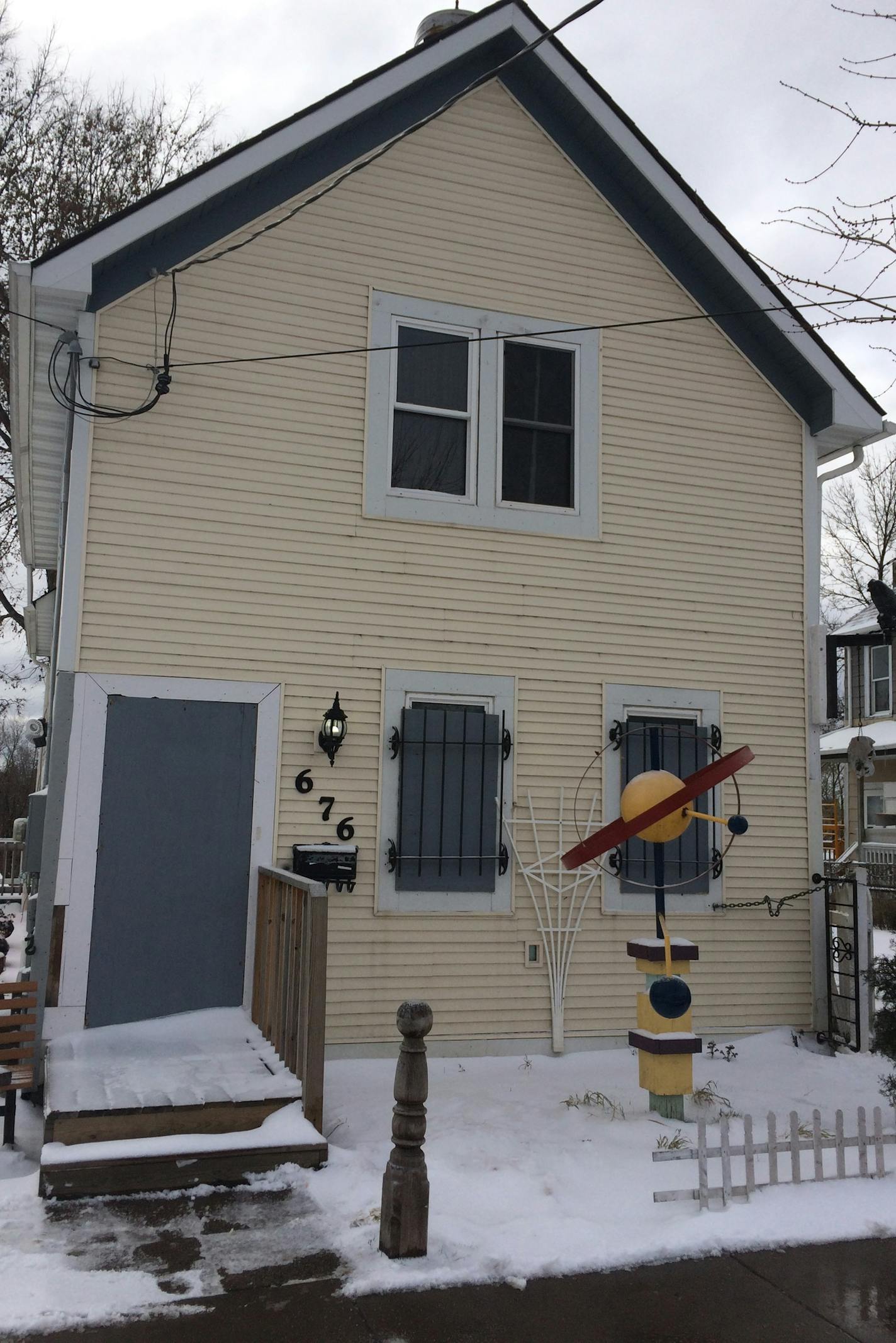 The house at 676 Wells St. in St. Paul is boarded, but it's not vacant. Arjo Adams still lives here, but if the city gets its way, it will demolish the house.