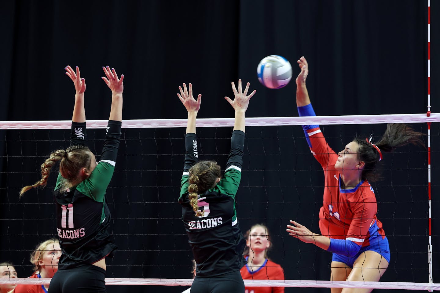 Pequot Lakes' Ella Kratochvil (14) sends the ball past Concordia Academy's Julia Bigalke (11) and Katherine Reinhard (5) completing one of her 23 kills in the match. Photo by Cheryl A. Myers, SportsEngine