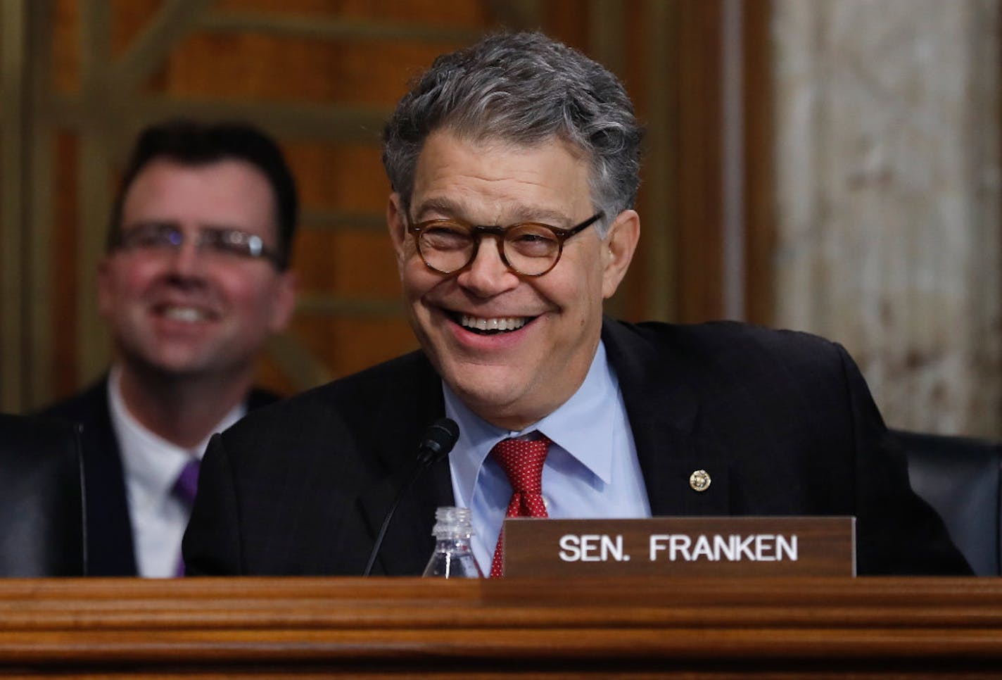 Senate Energy and Natural Resources Committee member Sen. Al Franken, D-Minn. laughs as he asks questions of and jokes with Energy Secretary-designate, former Texas Gov. Rick Perry on Capitol Hill in Washington, Thursday, Jan. 19, 2017, at Perry's confirmation hearing before the committee.