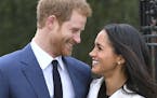 Britain's Prince Harry and Meghan Markle smile as they pose for the media in the grounds of Kensington Palace in London, Monday Nov. 27, 2017. It was 
