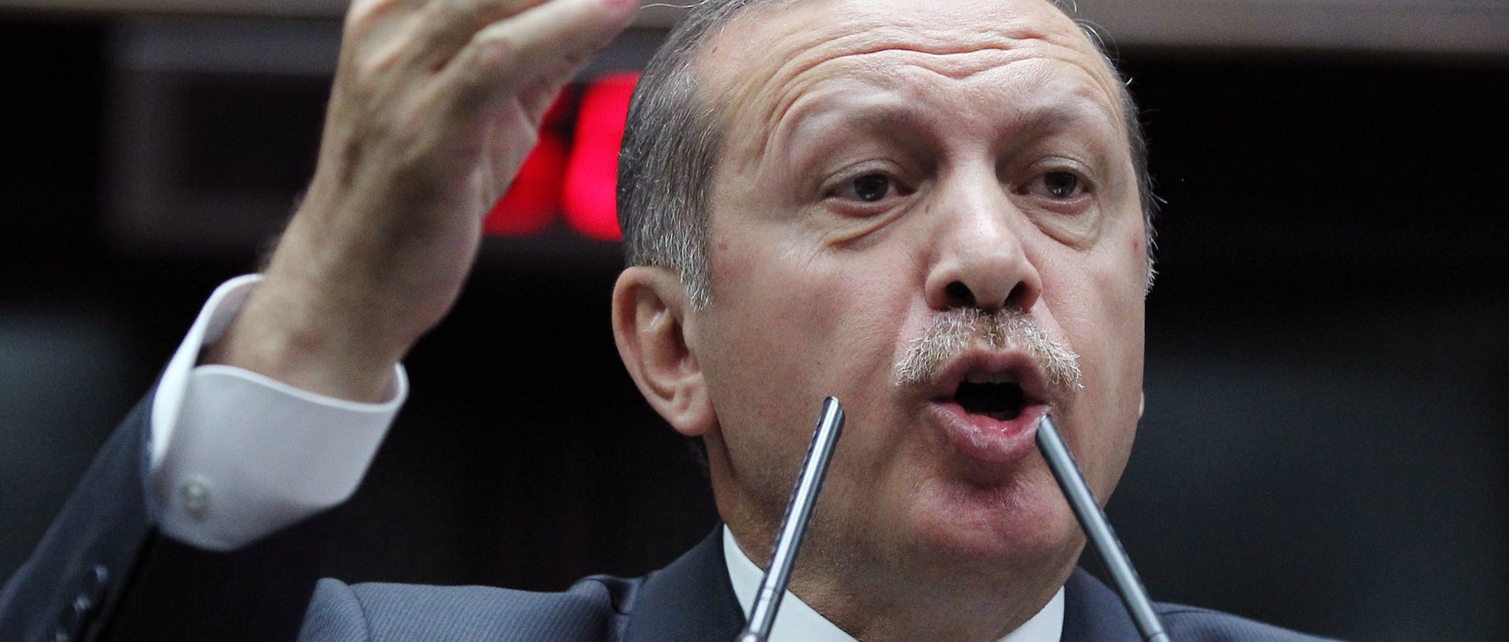 Turkish Prime Minister Recep Tayyip Erdogan addresses the members of his Islamic-rooted party in parliament in Ankara, Turkey, Tuesday, June 25, 2013. Turkish police on Tuesday detained at least 20 people allegedly involved in violent protests, as Erdogan continued to lash out at protesters ó and a BBC journalist ó he claimed were part of a conspiracy to harm Turkey. Erdogan reiterated that the protests were orchestrated by forces wanting to prevent Turkeyís rise. (AP Photo)