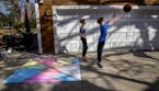 Alessa DiLorenzo, 12, left, and her brother Leo DiLorenzo, 10, played basketball near the chalk art they created in Edina. "It is fun to do when you'r