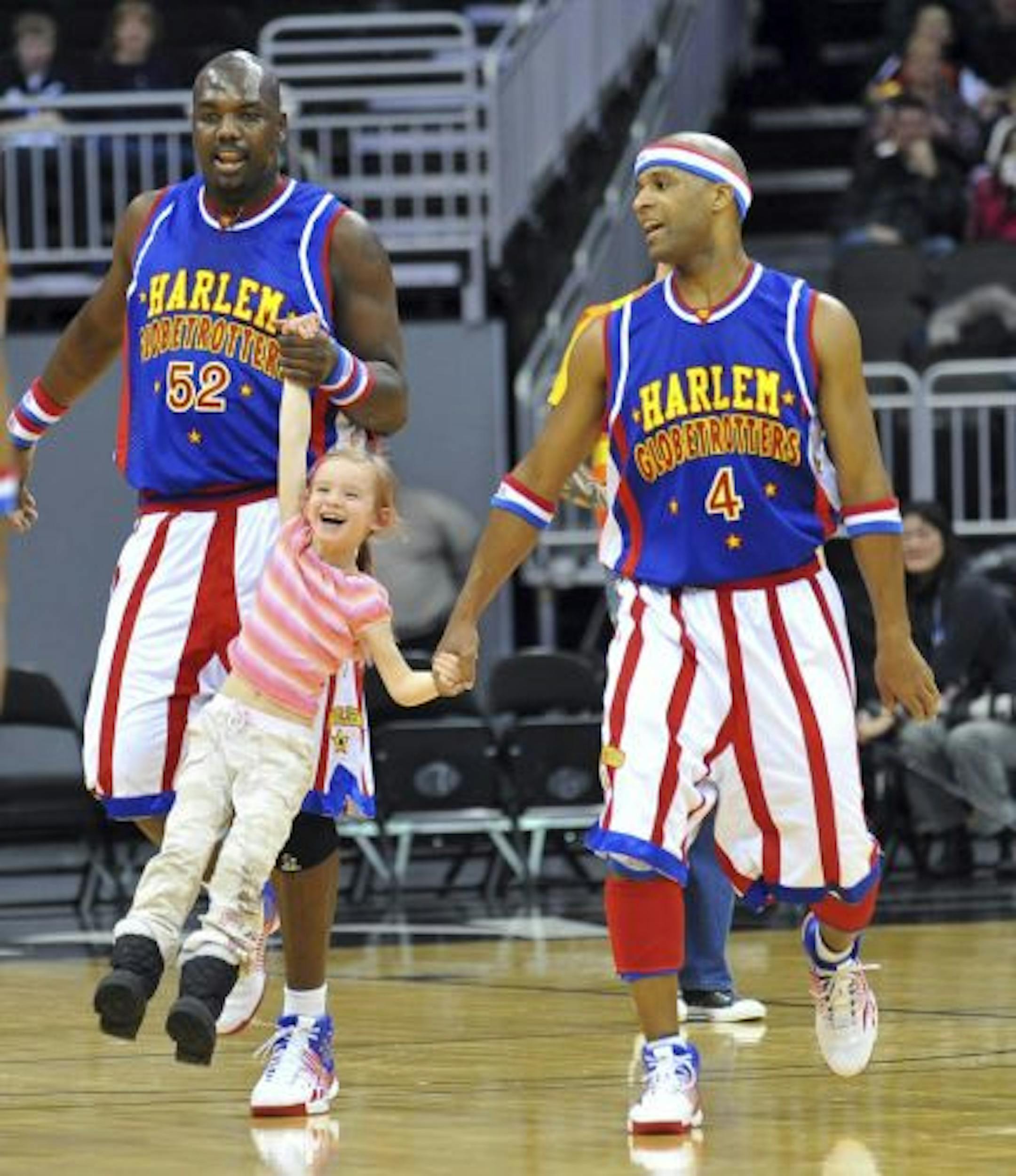 Big Easy and Flight Time have fun with a youngster during a Globetrotters performance.