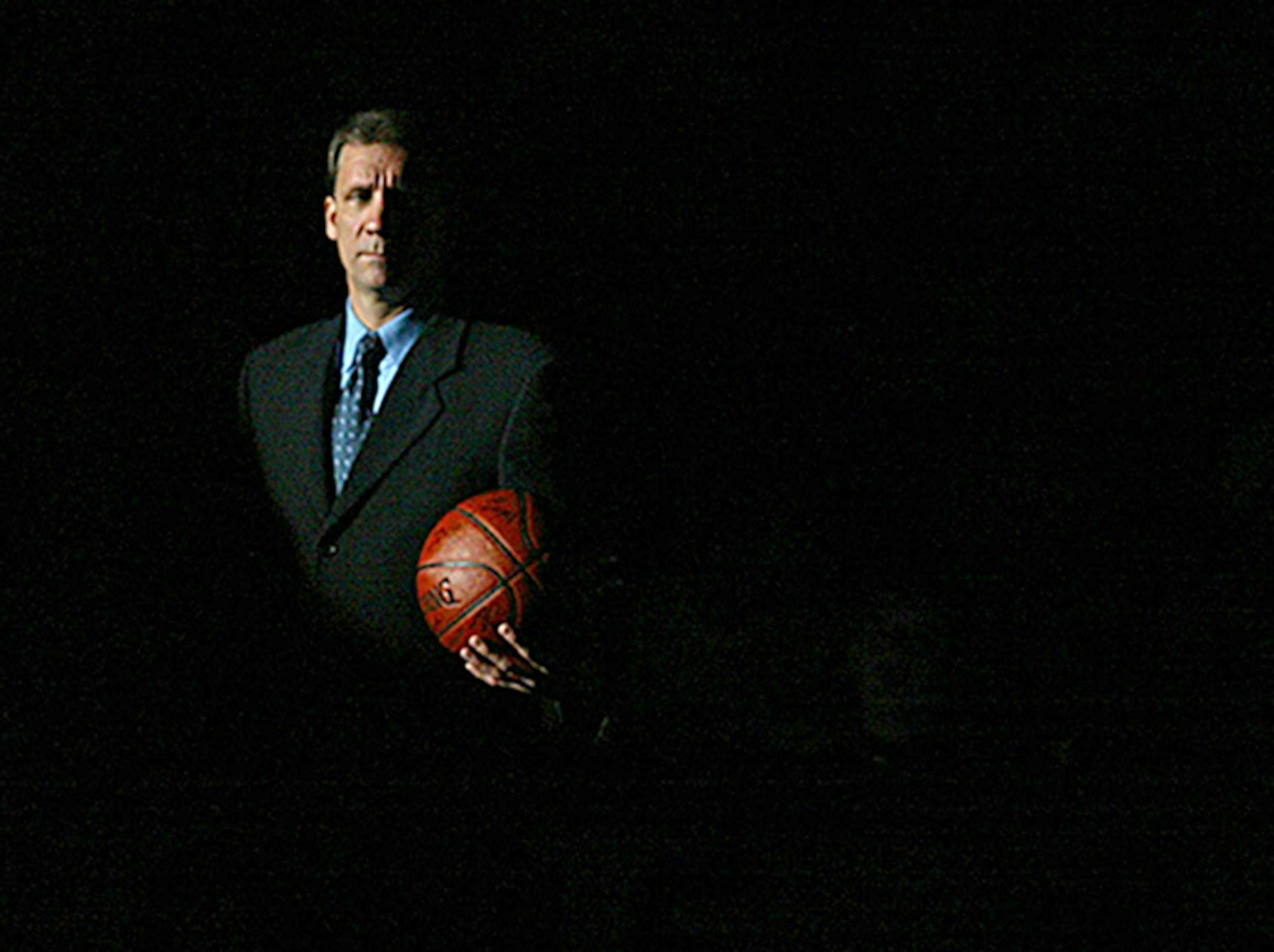 Timberwolves head coach Flip Saunders is cast in shadows during the team introduction on opening game of the season on Wednesday night at the Target Center. October 30, 2002, Minneapolis, MN Minnesota Timberwolves vs. Denver Nuggets