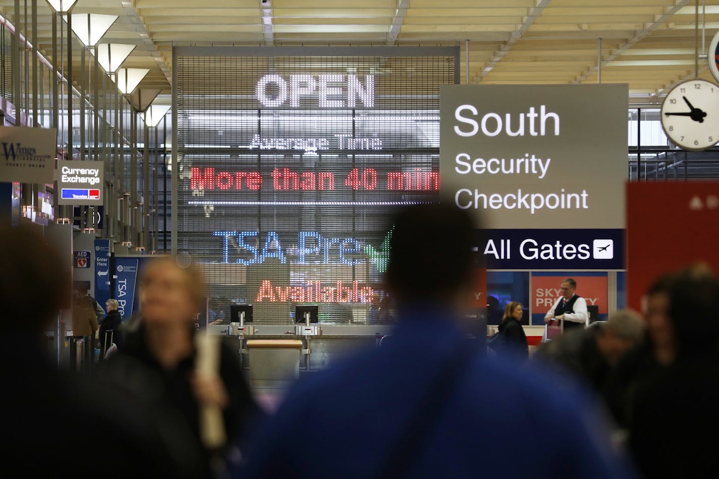 Signs alerted travelers to longer-than-usual wait times for TSA screening Monday at Minneapolis-St. Paul International Airport.