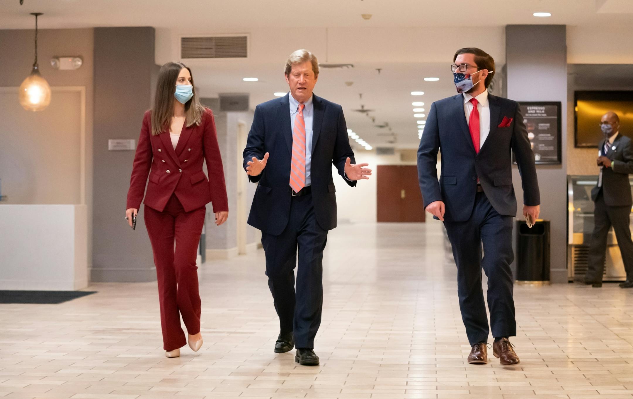 Jason Lewis talked with communications director Christine Snell and campaign manager Tom Szymanski on the way to speak to the crowd at the Election Night Party at the DoubleTree Hotel in Bloomington.