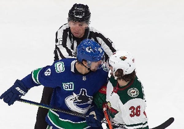 Vancouver's Antoine Roussel, as he is known to do, jawed mask-to-mask with Wild forward Mats Zuccarello.