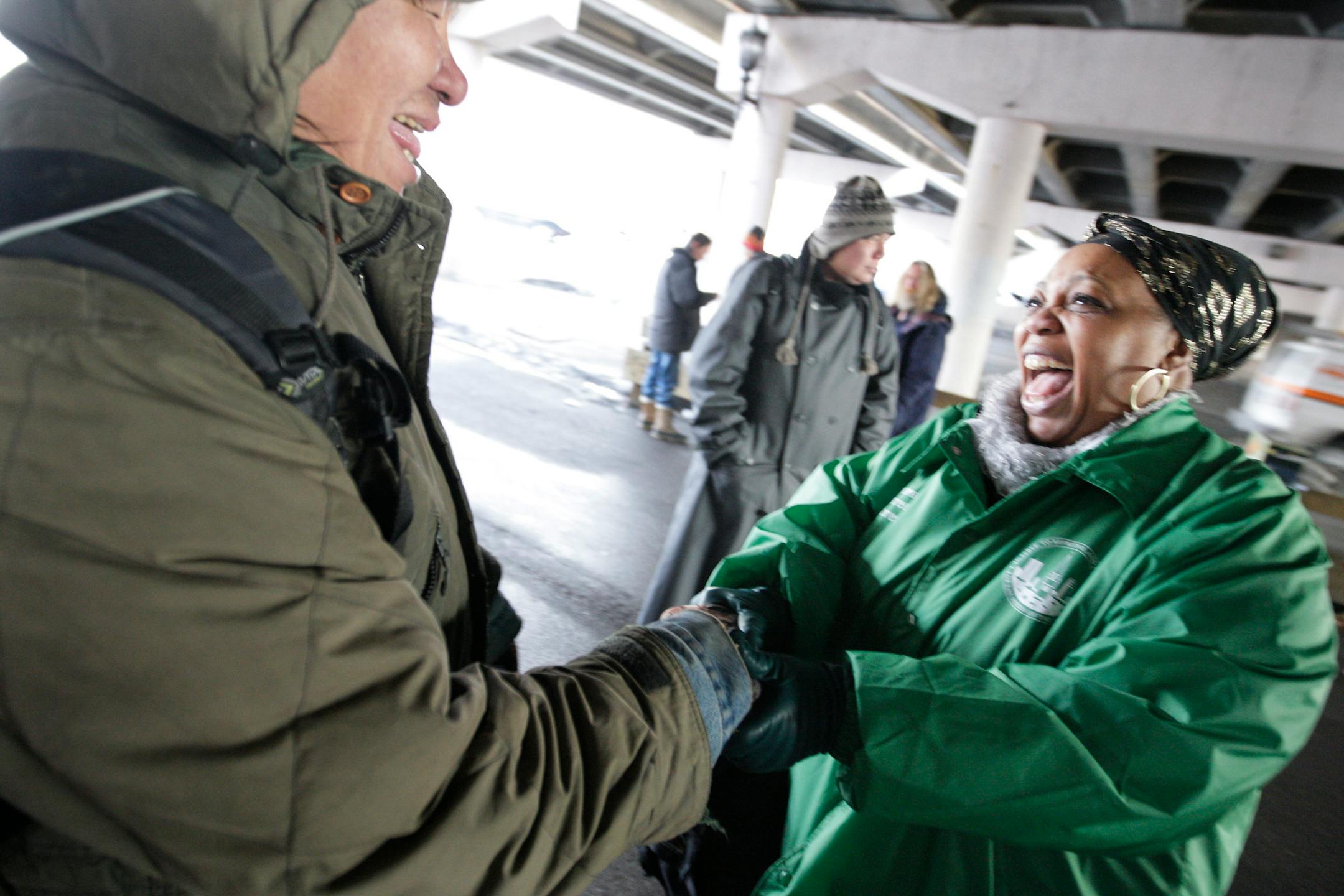 Dennis Wounded Shield, left, and St. Stephen's Human Services outreach worker Chiffon Williams were able to share a sense of humor as she brought mittens and hand warmers for the homeless.
