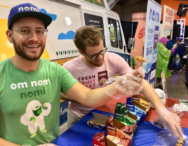 Two of Nomi’s founders Austin Hinkle, left, and Will Handke handed out samples at a food expo.