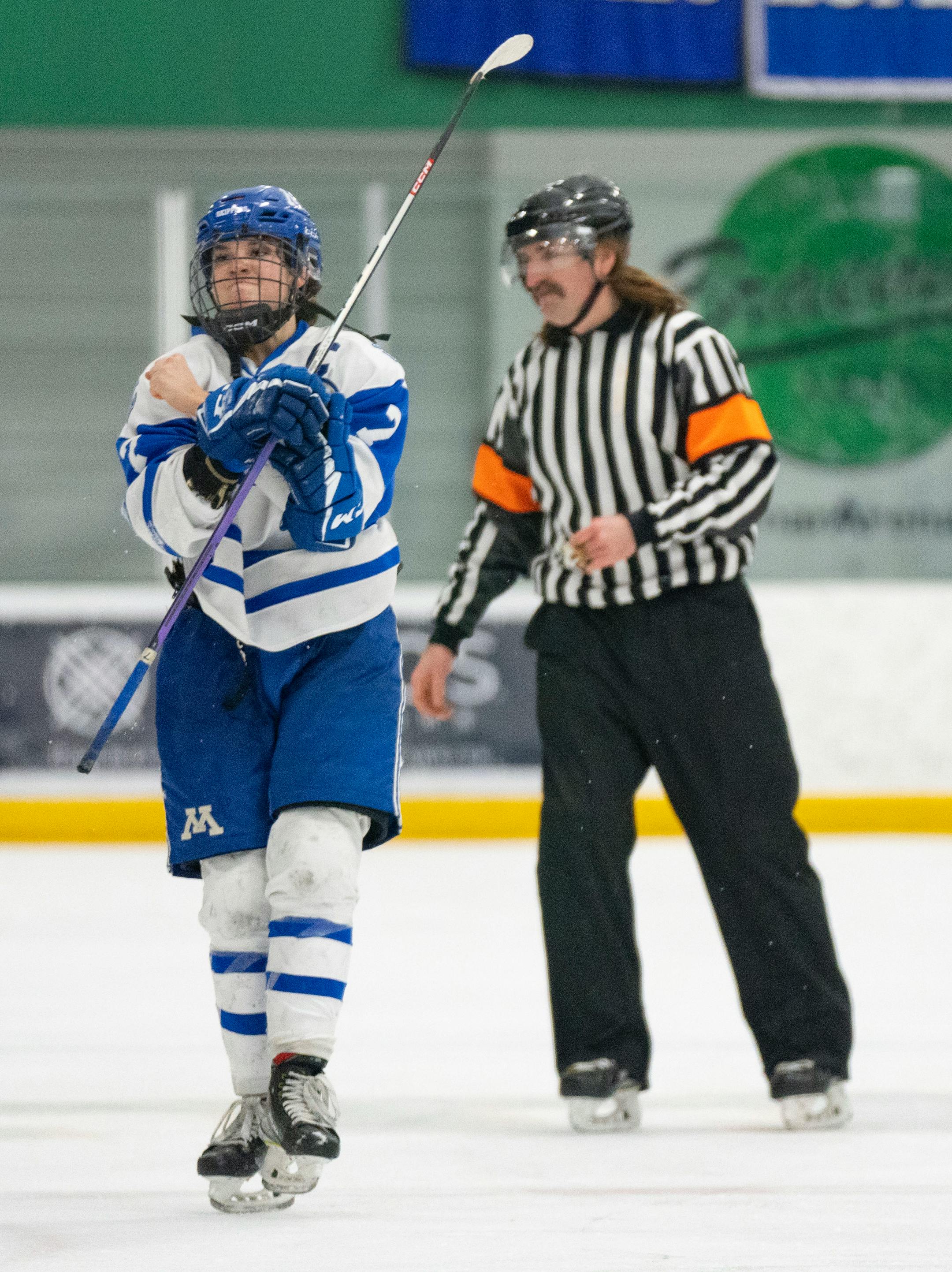 Minnetonka forward Grace Sadura  (7) gestures towards the student section after receiving a penalty in the final minute of play for cross checking.