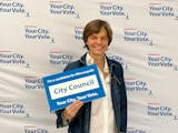 Minneapolis City Council Ward 12 candidate Becka Thompson holding a sign.